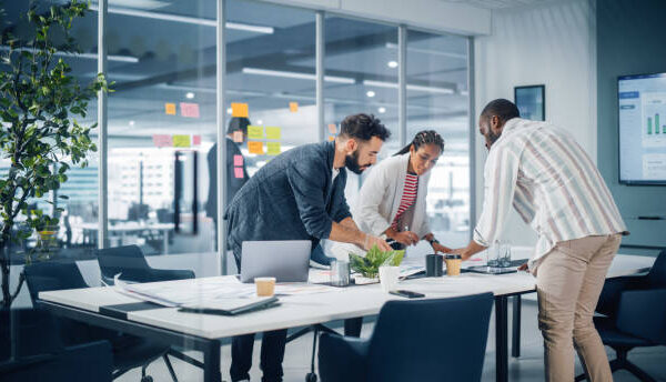 Diverse Team of Professional Businesspeople Meeting in the Office Conference Room. Creative Team Around Table, Black Businesswoman, African-American Digital Entrepreneur and Hispanic CEO Talking.