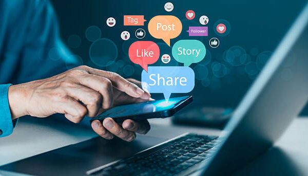 Hand interacting with a smartphone displaying "Like," "Share," and "Post" icons. Social media marketing, digital communication and online content promotion for brand building and audience connection
