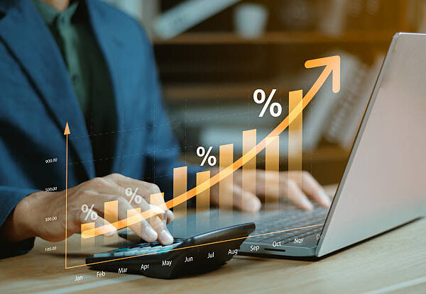 Interest rate concept, Business man using calculator with graph percentage symbol and up arrow, Growth of investments and profits, Dividends and long term investing to win Inflation, Calculate taxes