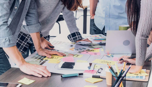 Close up creative designer applaud for job success at meeting table at office