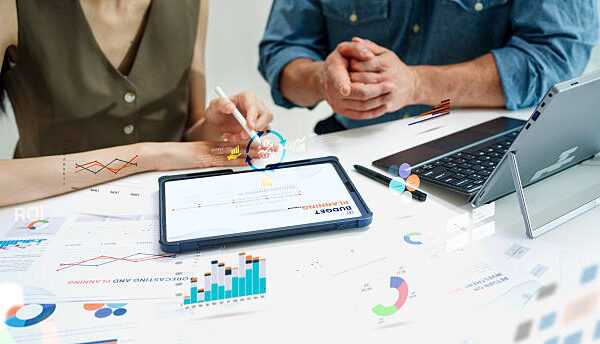 Close up Diverse Collaborative Business people meeting on devices computer with digital generate animated brainstorming the financial report paperwork document analyzing data or planning strategies displays a graph or chart in a modern business technology